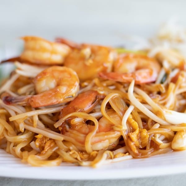 Close-up of Cilantro Thai Express Pad See Ew with shrimp, noodles, and bean sprouts.